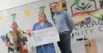 John Cotter Chair Person Mucklagh Communiyt Developmemnt presernt Lotto cheque to Lesley Nolan firs winner of 20k alon with fintan Lawlor